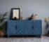 Navy blue solid wood buffet with M-shaped panel doors and traditional design in a dining room