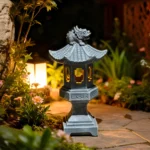 Chinese Zen auspicious palace lantern resin decoration with solar lights on a wooden table in a garden setting