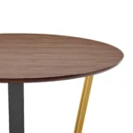 Round dining table for 4 with brown wood top and gold iron sled base in a cozy dining room