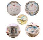 Japanese ceramic dinnerware set with hand-drawn cat design on blue rectangular plate and bowl
