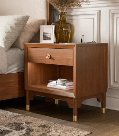 Modern nightstand with USB port, dovetail drawers, and gold capped legs in walnut finish