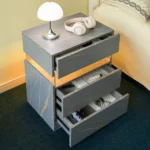 Modern LED nightstand with 3 drawers featuring illuminated acrylic panel in grey with gold veining