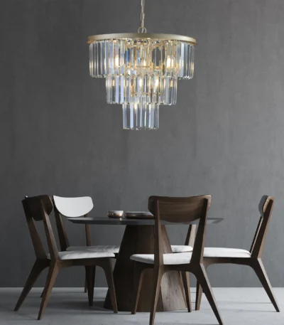 Goldoma 20-inch 3-tier crystal chandelier with gold frame and 7 candle-style lights, hanging in a modern living room.