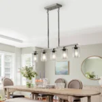 The chandelier suspended in a living room, complementing modern decor with its clear glass shades.