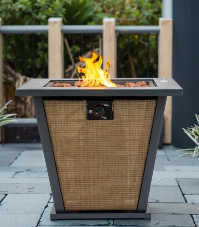 Outdoor gas fire pit column with dancing flames on a patio