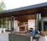 Rectangular propane fire pit table with flames on a patio