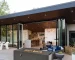 Rectangular propane fire pit table with flames on a patio
