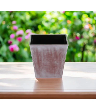 Brown and off-white recycled plastic square planter with tone-on-tone textural design, set on a wooden deck with