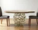 47-inch round acacia live edge dining table with brass base in a modern dining room