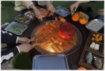 Outdoor fire pit chimnea on patio with flames and grill grate