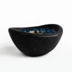 Black concrete mini tabletop fire pit with smokeless ethanol flame on a wooden table