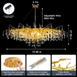 Modern crystal chandelier hanging in a dining room with gold finish and tree branch design