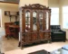 Elegant glass china cabinet in cherry oak finish displaying fine china and decor
