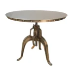 Adjustable height round dining table with antiqued nickel three-leg pedestal base and rivet detailing