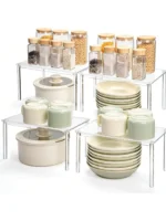 Clear acrylic countertop storage shelves with stacked spice jars on a kitchen counter