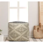 Goldoma 20-inch beige cotton tribal pouf ottoman with tufted stitching used as foot rest in living room