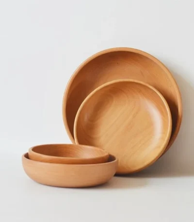 Natural wooden salad bowl with fresh greens and cherry tomatoes