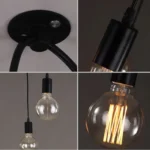 Close-up of black metal spider chandelier with exposed Edison bulbs and adjustable arms, showing textured matte finish.
