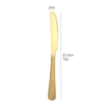 Elegant gold flatware set with fork, knife, and spoon on a white tablecloth