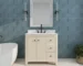 Modern freestanding bathroom vanity with sink, soft close drawers, and a sleek white countertop in a bright bathroom.
