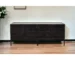 Modern black console table with solid wood top and iron base in living room