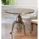 Adjustable height round dining table with antiqued nickel three-leg pedestal base and rivet detailing