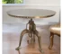 Adjustable height round pedestal dining table with antiqued nickel pedestal base in a modern dining room