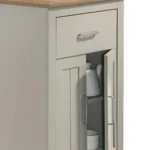 Small round dining table in oak and white finish with storage shelf in a cozy kitchen
