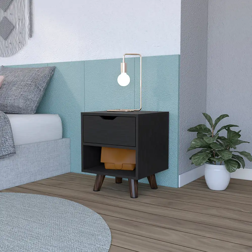 H7343aadd7317478c84b77188b078ef29i.webp Modern nightstand with drawer and open shelf in black finish with wooden legs on a bedroom floor next to a bed