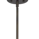 Antique bronze hanging light installed above a wooden dining table in a cozy villa setting.