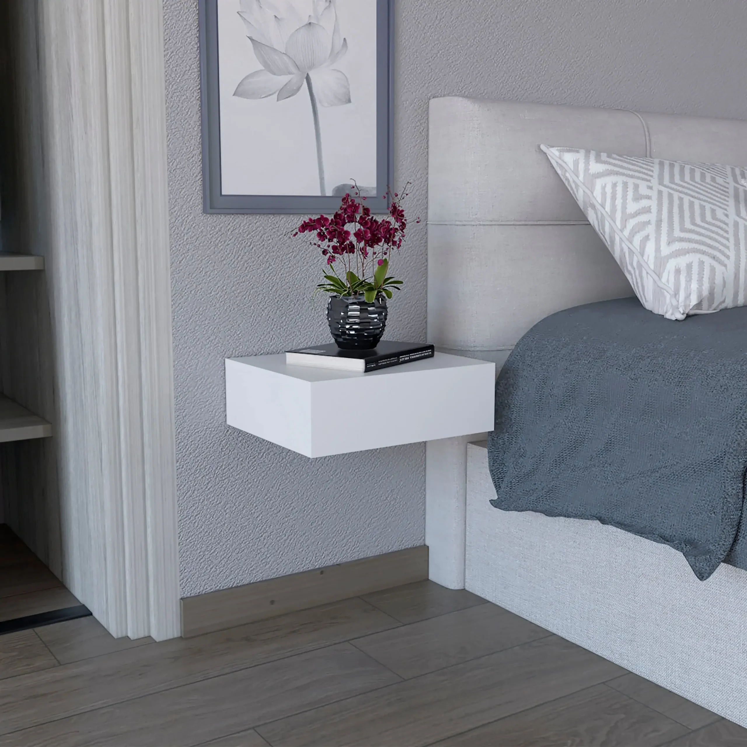 Milano floating nightstand with drawer mounted on white wall, holding a lamp and book