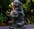 Solar elephant statue glowing at night in garden with warm LED light