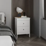 Modern white nightstand with two drawers beside a bed in a contemporary bedroom