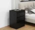 Black nightstand with drawers in a modern bedroom setting