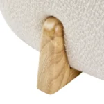 Goldoma white fabric footrest stool with splayed rubber wood legs in a living room near a sofa