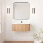 Floating curved bathroom vanity cabinet in white with marble countertop, mounted on wall, front view.