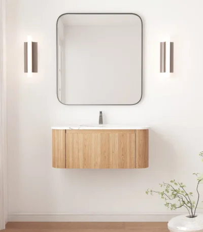 Floating curved bathroom vanity cabinet in white with marble countertop, mounted on wall, front view.