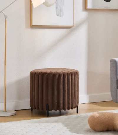 Goldoma faux fur pouf ottoman with black metal legs in a modern living room setting