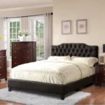 Modern faux leather queen bed with tufted upholstered headboard in a stylish bedroom setting