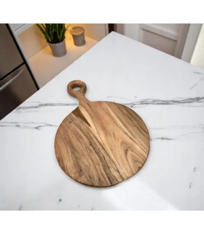 19-inch round acacia wood chopping block with rich brown grain on kitchen counter