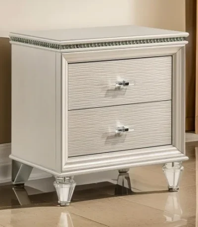 Goldoma traditional 2-drawer nightstand with diamond clear acrylic legs in pearl white finish placed next to a bed