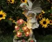 Solar angel statue glowing in a garden at night