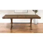 Goldoma 64-inch brown solid wood dining table with removable leaf and trestle base, set in a dining room