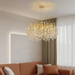 Modern crystal chandelier tree branch design illuminating a dining room