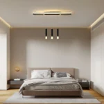 Remote control for the dimmable LED chandelier placed next to the light fixture on a wooden table.