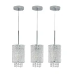 Chrome and crystal modern pendant chandelier, spiral design, suspended over a wooden dining table.