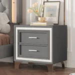 Modern velvet nightstand with silver glitter strip decor and two drawers, placed beside a bed in a bedroom