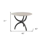 Goldoma 40 inch round marble dining table with black metal three-leg base in a modern dining room setting