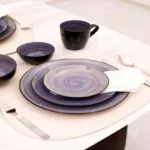 Hand painted dinnerware set with floral patterns on a wooden table