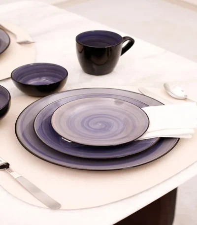 Hand painted dinnerware set with floral patterns on a wooden table